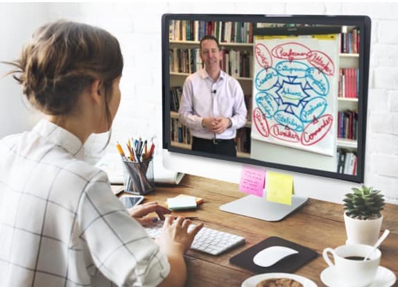 Woman at laptop with Bill image onscreen Shutterstock 3.30.2020